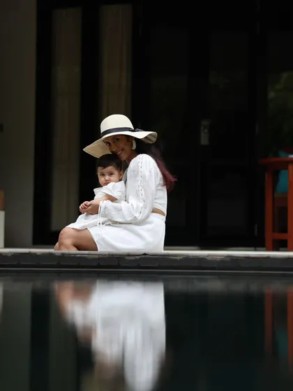 By the pool with my daughter. We are a new version of ourselves every day. Live to the fullest.