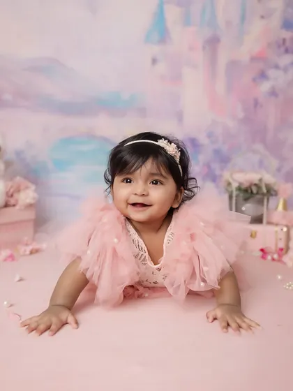 A happy princess in her castle. This baby is enjoying her tummy time during her 6-month milestone session.