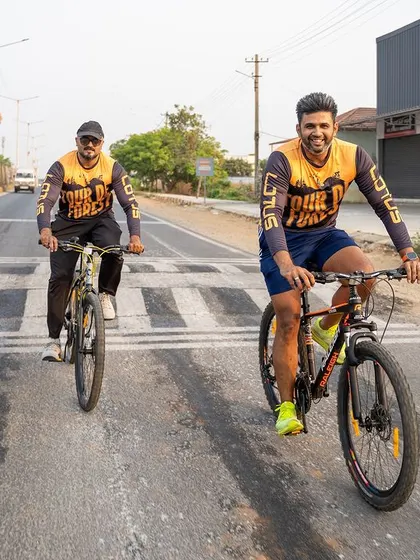 Two friends cycle side-by-side, enjoying the journey and motivating each other.