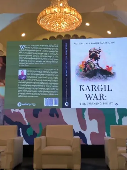 The main stage display for the book launch, featuring the book cover on a large LED screen.