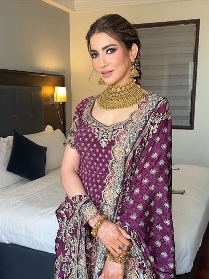 The full look. The rich color of her outfit is beautifully complemented by the warm tones in her makeup.