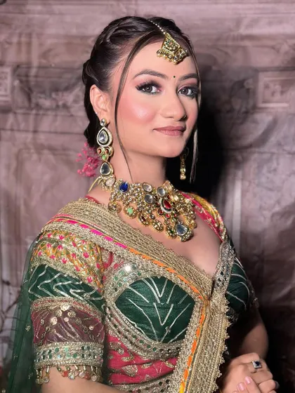 A close-up portrait in the multi-color lehenga, focusing on the navratna-style jewellery.