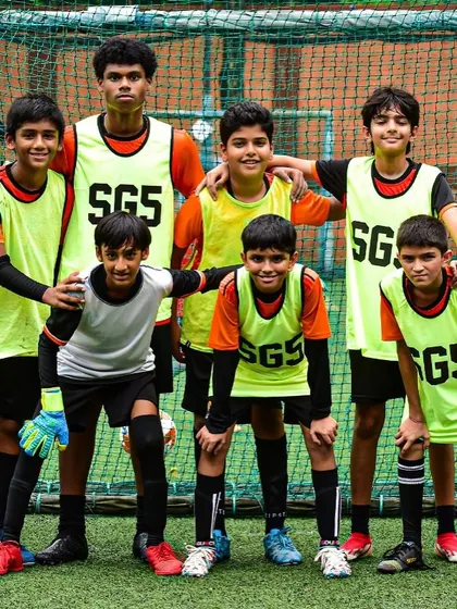 Players in training bibs, all smiles after a good session. We believe in working hard and enjoying the game.