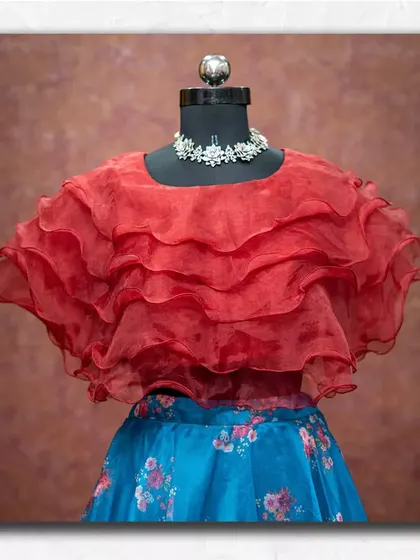 A closer look at the trendy ruffled organza top, a fun and stylish piece available for rent.