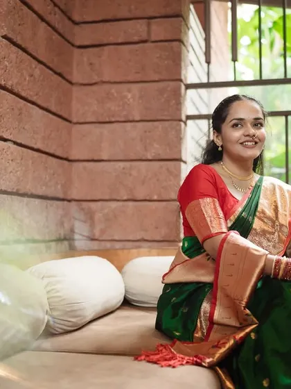 A lovely portrait of the bride looking directly at the camera, her gentle smile and elegant posture captured in a beautifully lit indoor setting.