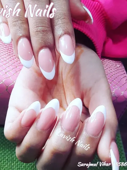 A beautiful set of long, oval-shaped nails with a classic French manicure, perfect for an elegant and traditional wedding.