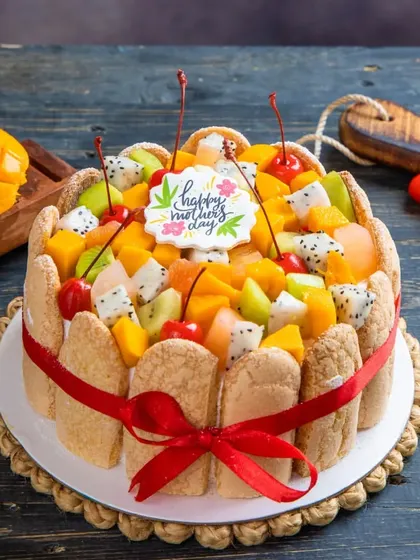 Our Exotic Fruit Cake is a fresh and vibrant option for any celebration. It's topped with a colourful assortment of seasonal fruits like kiwi, dragon fruit, mango, and cherries.