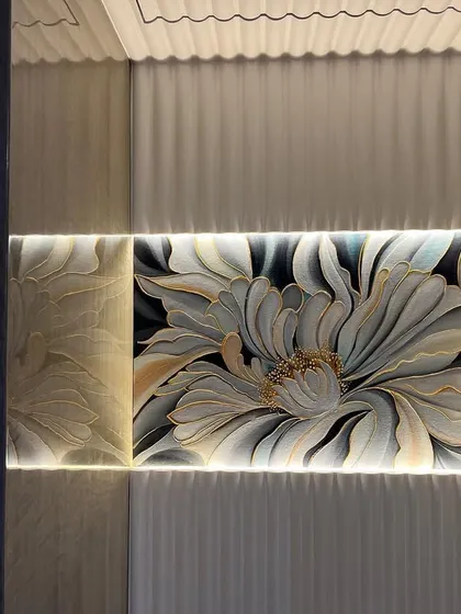 A second image of the backlit flower painting, showing how it enhances the texture of the surrounding wall panels and adds a soft, ambient light to the room.