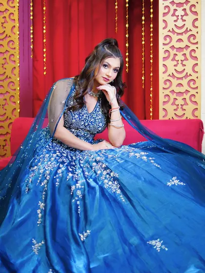 A seated portrait in the blue ball gown, exuding elegance and grace.
