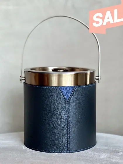 A studio shot of the ice bucket, highlighting its clean lines and the subtle V-shaped detail in the leather. It is a perfect example of modern elegance.