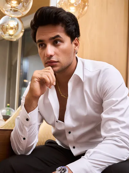 Cricketer Abhishek Sharma in a custom Zafir and Shadab look. The open white shirt paired with black trousers is a classic combination that’s both sharp and effortlessly cool.
