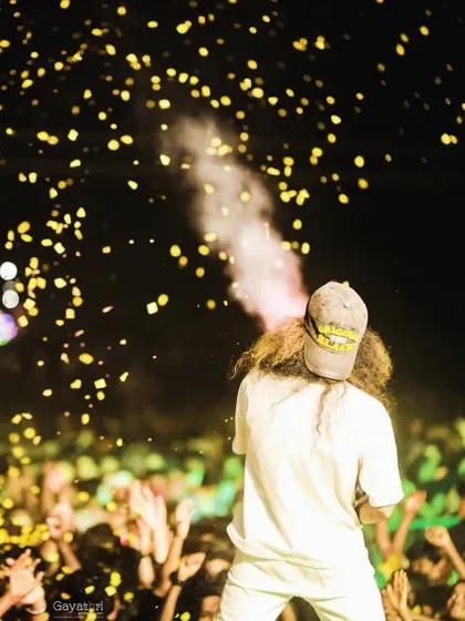 A view from behind as I operate a CO2 gun, blasting cool smoke and golden confetti over the audience.