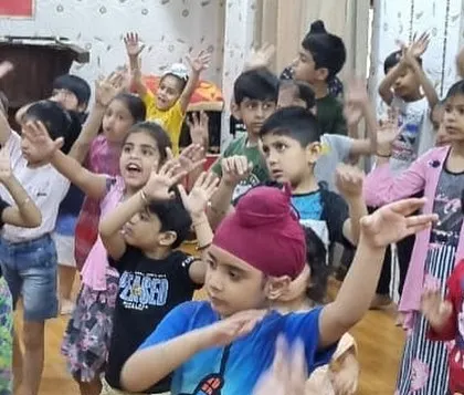 Look at them go. This group of enthusiastic campers is fully engaged in a high-energy dance number, learning new steps and coordinating their moves as a team.