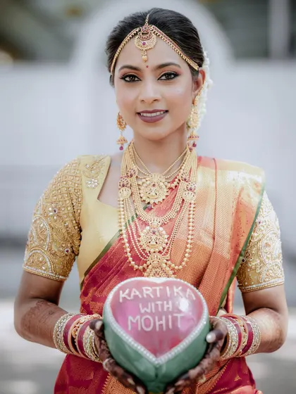 The bride holding a coconut painted with her and the groom's names. It's a unique and personal detail that we love to highlight in our photography.