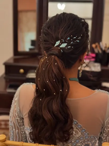 The details of this modern ponytail are stunning. The twisted top section adds texture, while the accessories provide a beautiful pop of color.