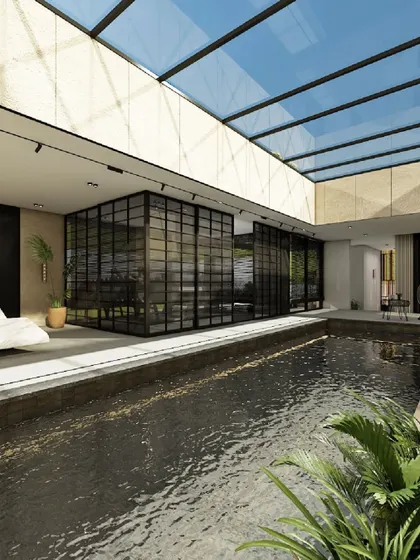 A wider view of the indoor pool, showcasing the expansive glass partitions that create a fluid connection between the water and the adjoining interior spaces. The design embodies a balance of simplicity, luxury, and natural light.