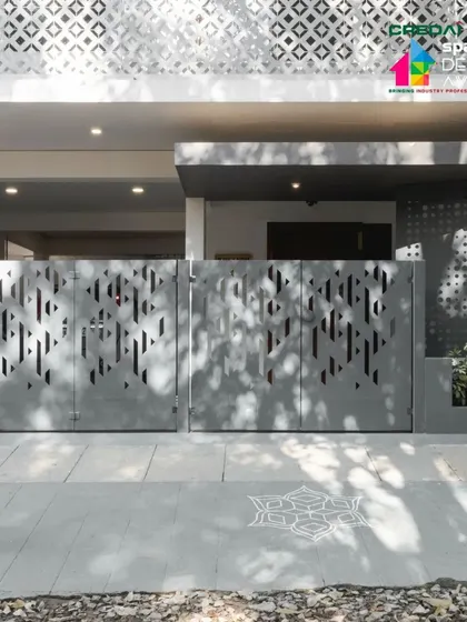A person walks past the custom-designed gate, highlighting the home's connection to the public realm and its contribution to the street's aesthetic.