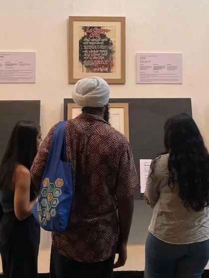 Visitors admire the intricate calligraphy art at the "Scripted Dialogues" exhibition. Our gallery provides a space for quiet contemplation and appreciation of diverse artistic traditions.