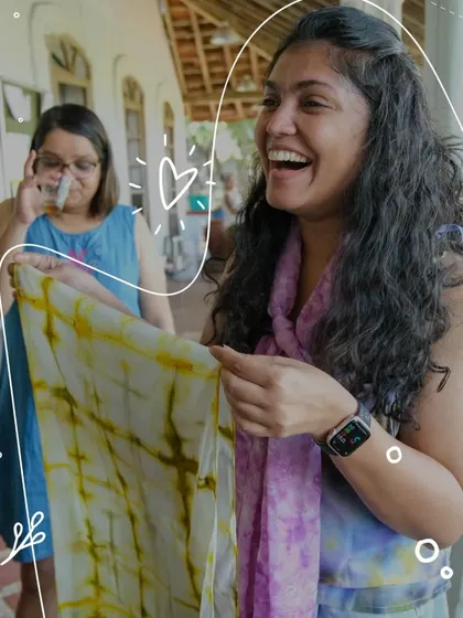 The pure joy of seeing your creation for the first time. This participant's laughter captures the magic of the Shibori reveal, where the combination of your work and the dye's journey creates a beautiful surprise.