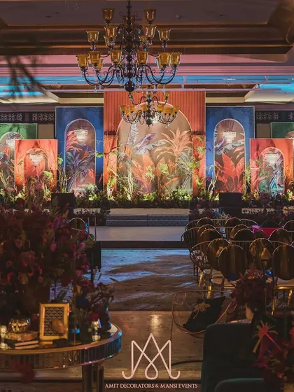 A contemporary sangeet night with a colorful, tropical-themed backdrop. The design captures the spirit of the client and the essence of the space for a vibrant celebration.
