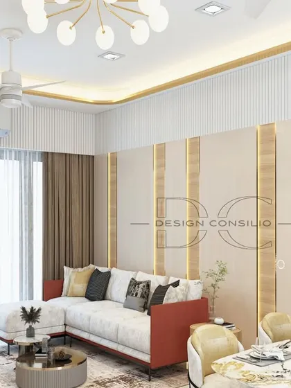 This angle shows the living and dining area, highlighting the use of gold accents and fluted panels on the wall to create a sense of luxury and cohesion. The color palette is kept light and neutral to make the space feel larger.