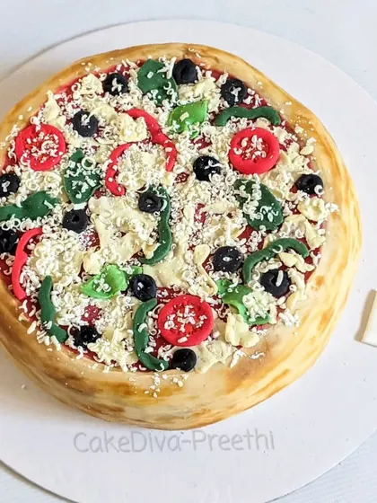 Pizza or cake? This hyper-realistic pizza cake is one of my favorite novelty designs. All the toppings, from the cheese to the veggies, are made from fondant and edible materials.