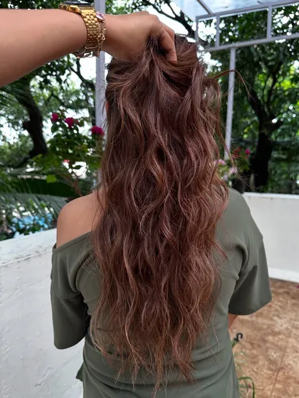Cascading hair with ribbon highlights. The layers and color work together to create a waterfall effect.