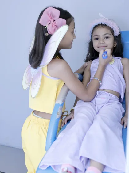 Pretend play is part of the party fun. Here, two friends enjoy a make-believe makeover session.