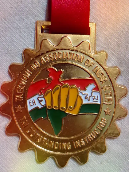The medal I received along with the Outstanding Instructor award from the Taekwon-do Association of India (TAI).