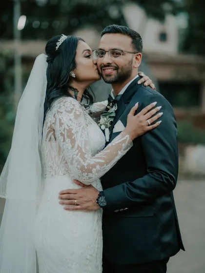 A sweet kiss filled with joy and affection after a Catholic wedding ceremony. These are the unscripted, heartfelt moments that truly define your wedding day.