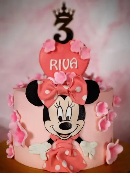 Who doesn't love a Minnie Mouse cake? This pink cake features a big Minnie face, a polka-dot bow, and a custom name plaque for the birthday girl.