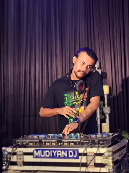 A focused shot of me at my Pioneer DJ setup during a wedding event.