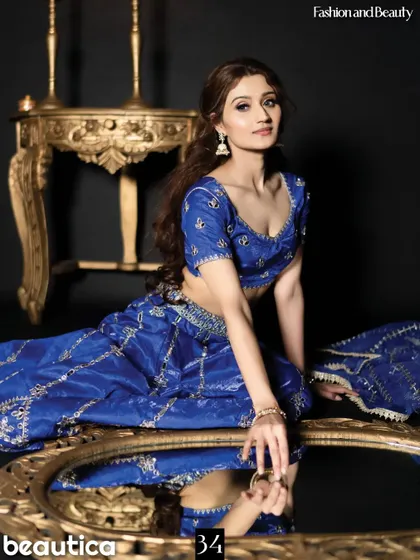 A beautiful studio shot from the same Beautica Magazine feature. The golden mirror and royal blue outfit create a rich and luxurious feel.