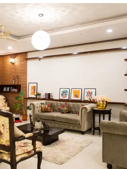 Neeleesh wanted a modern home that also reminded him of his roots. I designed this living room with a blend of contemporary furniture and traditional floral-upholstered chairs against a warm brick wall.