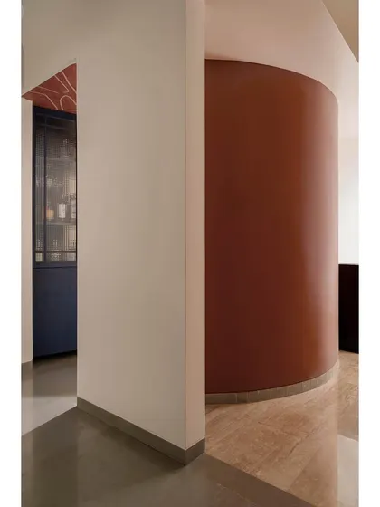 A detail of the curved wall and bar cabinet in Apartment 1005, showcasing our use of bold color and form.