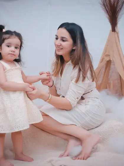 A full-length view of the mother and daughter in our boho studio, showing the soft, dreamy atmosphere we create.
