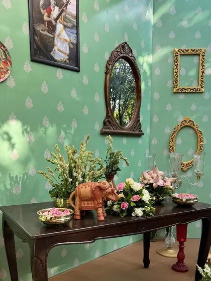The reflection in the antique mirror adds depth to the room, showcasing the layers of the decor.