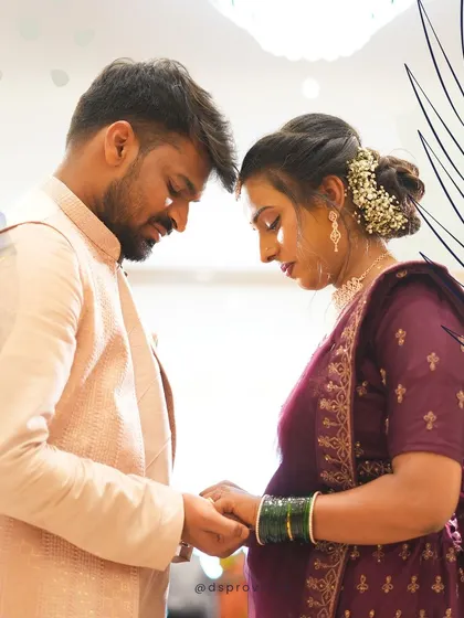 An artistic shot of an expecting couple during their baby shower ceremony. The soft lighting and close framing create a tender and prayerful mood.