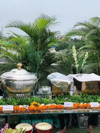 An outdoor chaat and biryani station set up for an Independence Day celebration, featuring pani puri, juice dispensers, and fresh biryani.