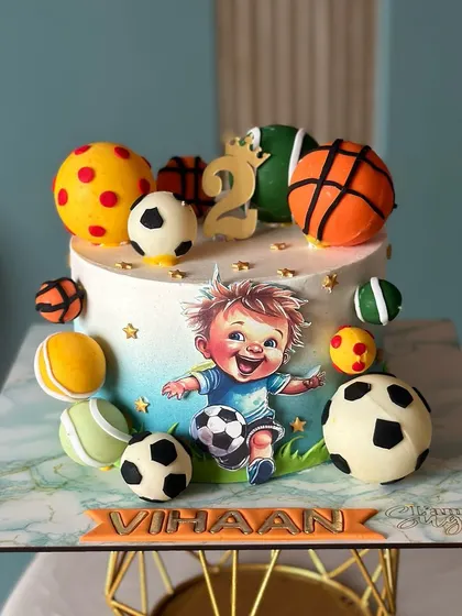 Kick off the celebrations with this adorable little footballer cake. Covered in different sports balls, it's perfect for a tiny sports star's second birthday.