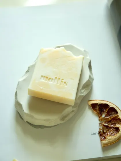 Wake up your senses with this energizing blend of orange and bergamot. This bar rests on one of my handmade concrete trays, next to a dried orange slice.