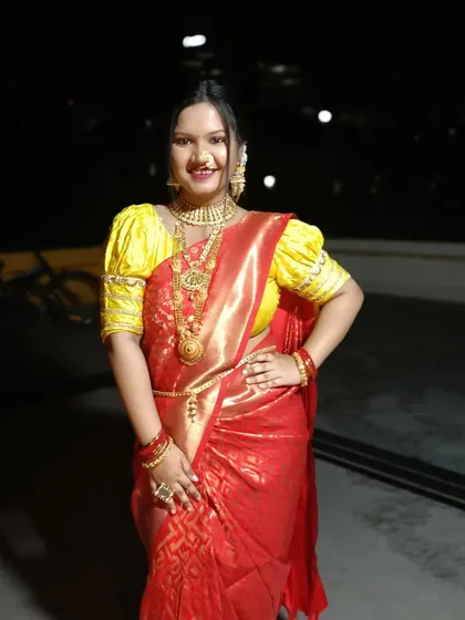 A happy client in her red and yellow traditional saree. The Nivi drape is comfortable and allows the rich texture of the silk to shine.
