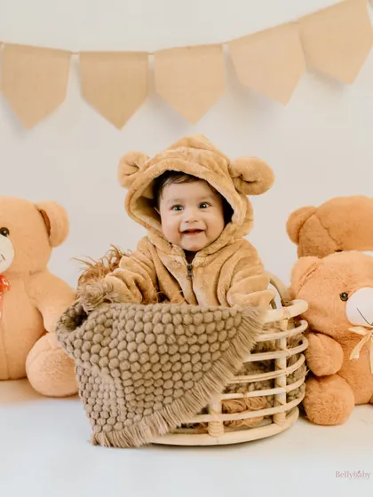 The cutest teddy bear in a basket, surrounded by his fluffy friends. My bear onesie is a client favorite for its undeniable cuteness.