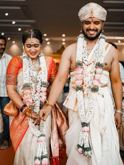 The couple walks hand in hand, their smiles showing the joy of starting their new life together.
