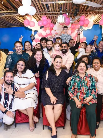 A big group photo capturing all the friends and family who came to celebrate the first birthday.