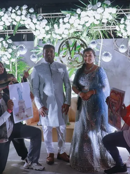 A picture perfect moment after a surprise engagement flashmob. Our dancers pose with the happy couple on stage, holding up custom illustrated portraits as part of the celebration.