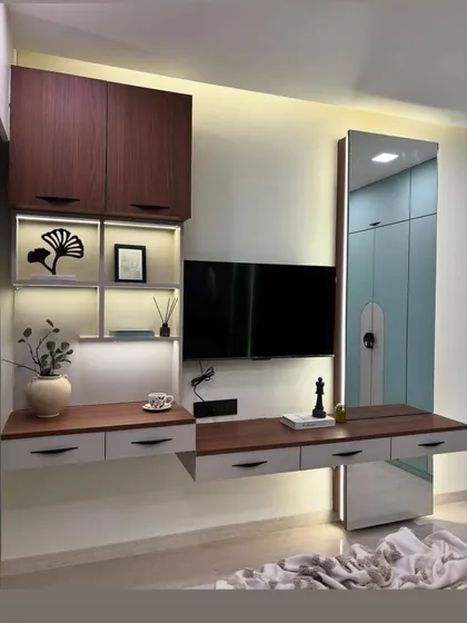 This floating TV and dressing unit was designed to be both functional and stylish. It combines wood and white finishes, with a full length mirror and drawers for storage.
