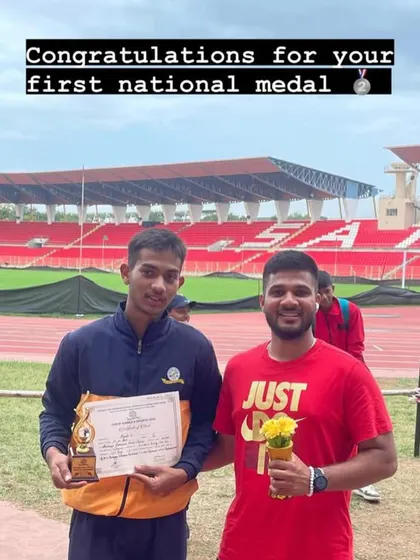 Celebrating a first national medal. A proud moment for our young athlete and his coach at the stadium.