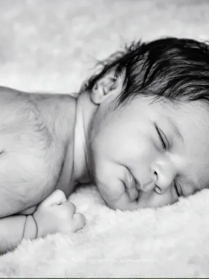 A peaceful slumber. This classic black and white close-up captures the serene beauty of a newborn's sleeping face.