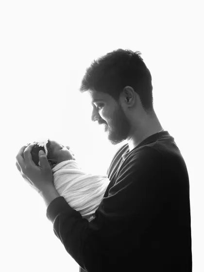 The look of pure adoration. I love capturing the connection between a father and his new baby in these simple, powerful portraits.